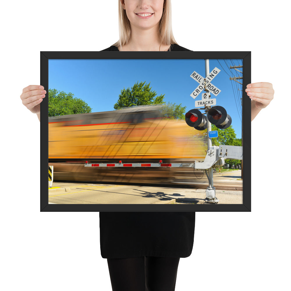 Freight Train Roaring Through an Active Railroad Crossing - Framed Print