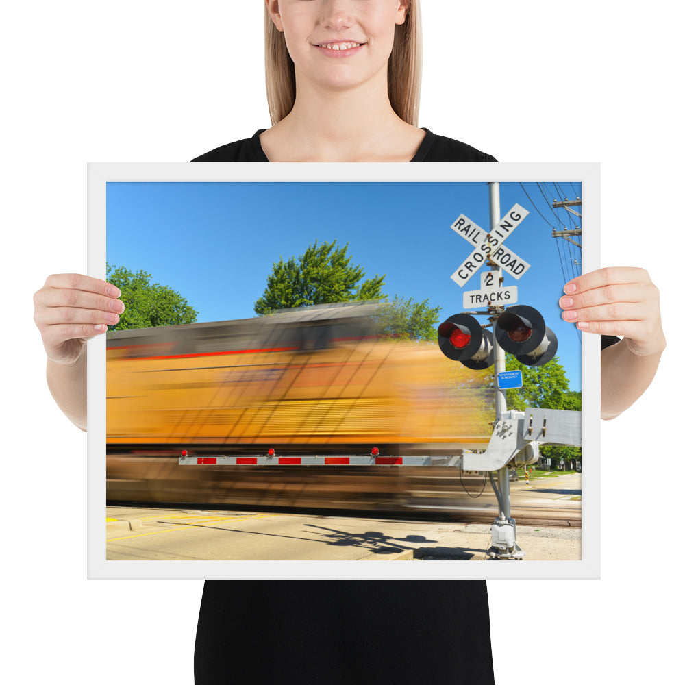 Freight Train Roaring Through an Active Railroad Crossing - Framed Print