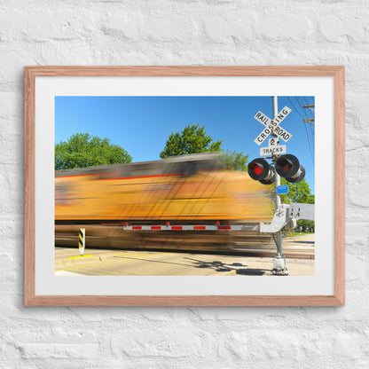 Freight Train Roaring Through an Active Railroad Crossing - Framed Print