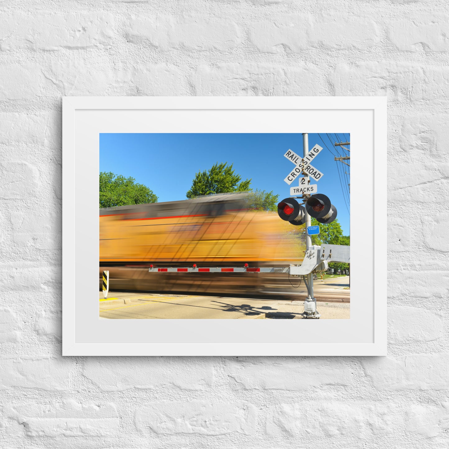 Freight Train Roaring Through an Active Railroad Crossing - Framed Print